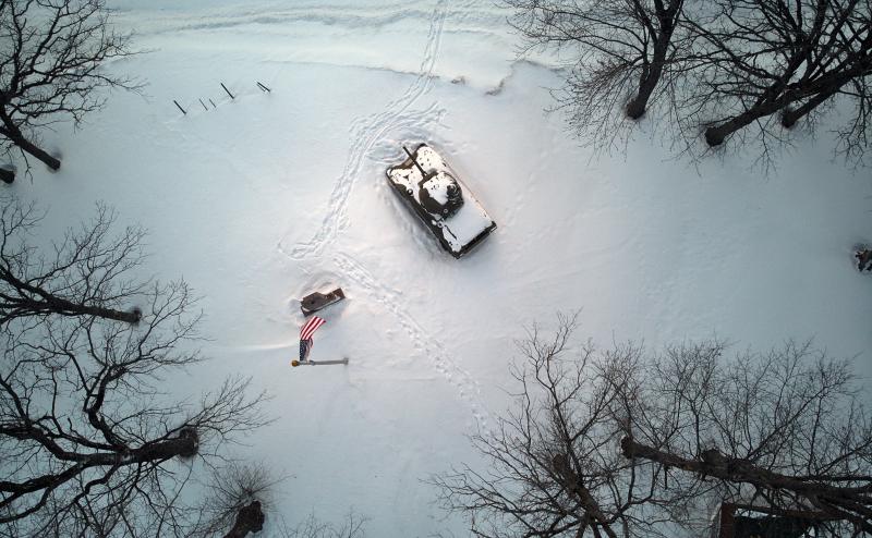 Drone photo looking straight down on a old snow covered tank in the memorial park in Crosby, Minnesota.