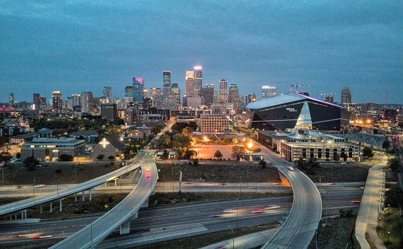 Minneapolis skyline around dusk, including the Vikings stadium.
